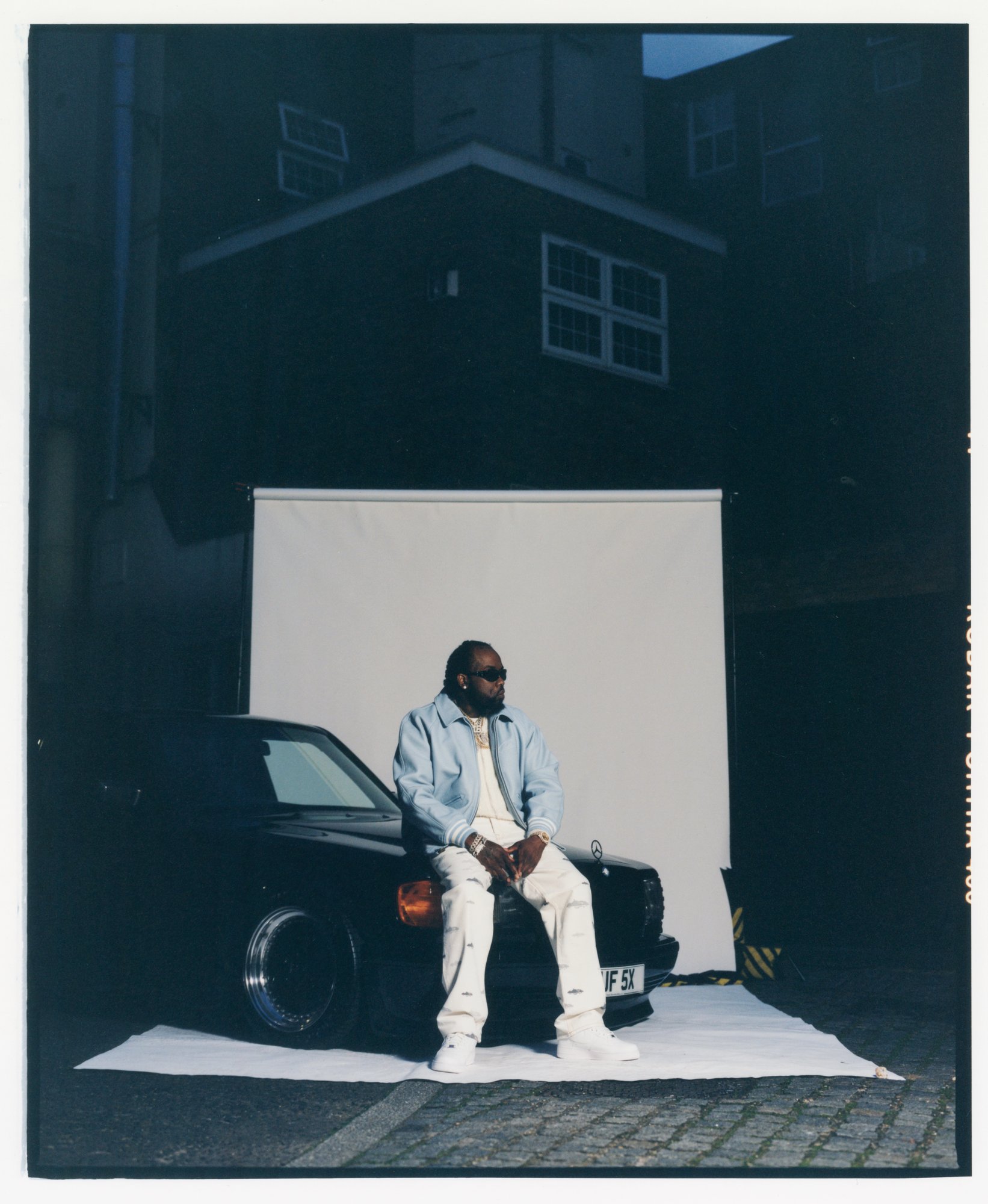 Unretouched frame — number plate and hazard tape visible