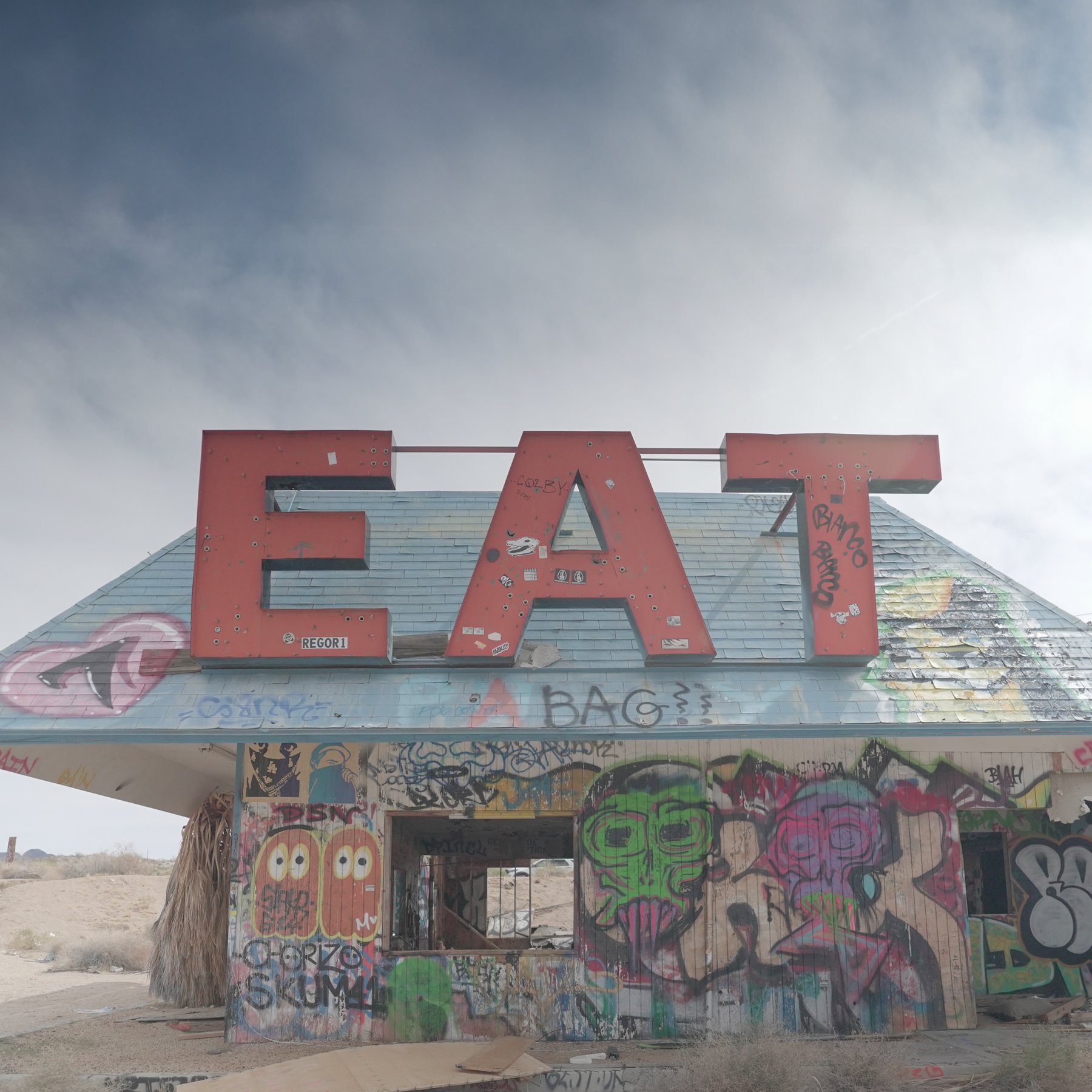 Original photograph — EAT sign close-up before compositing and type