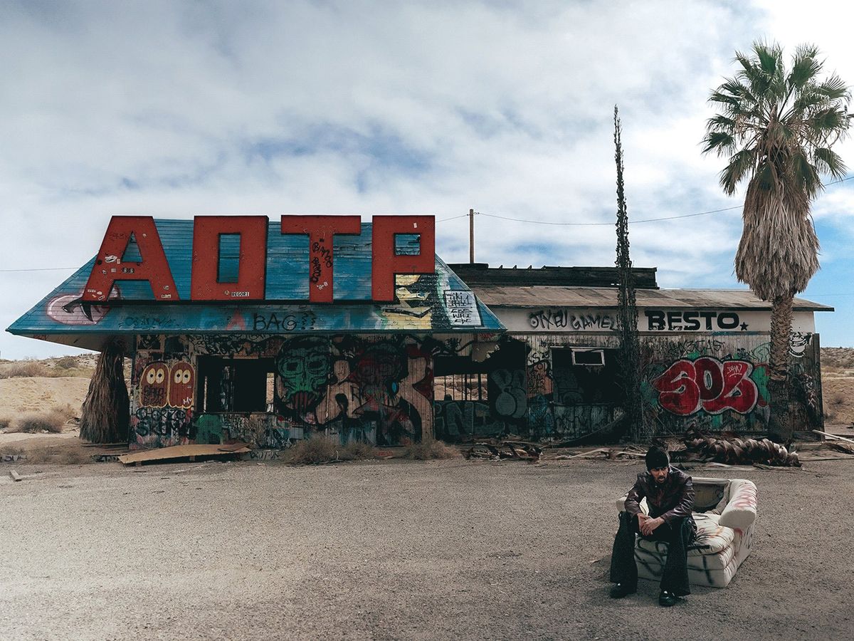 AOTP — Laicositna seated outside a graffitied building