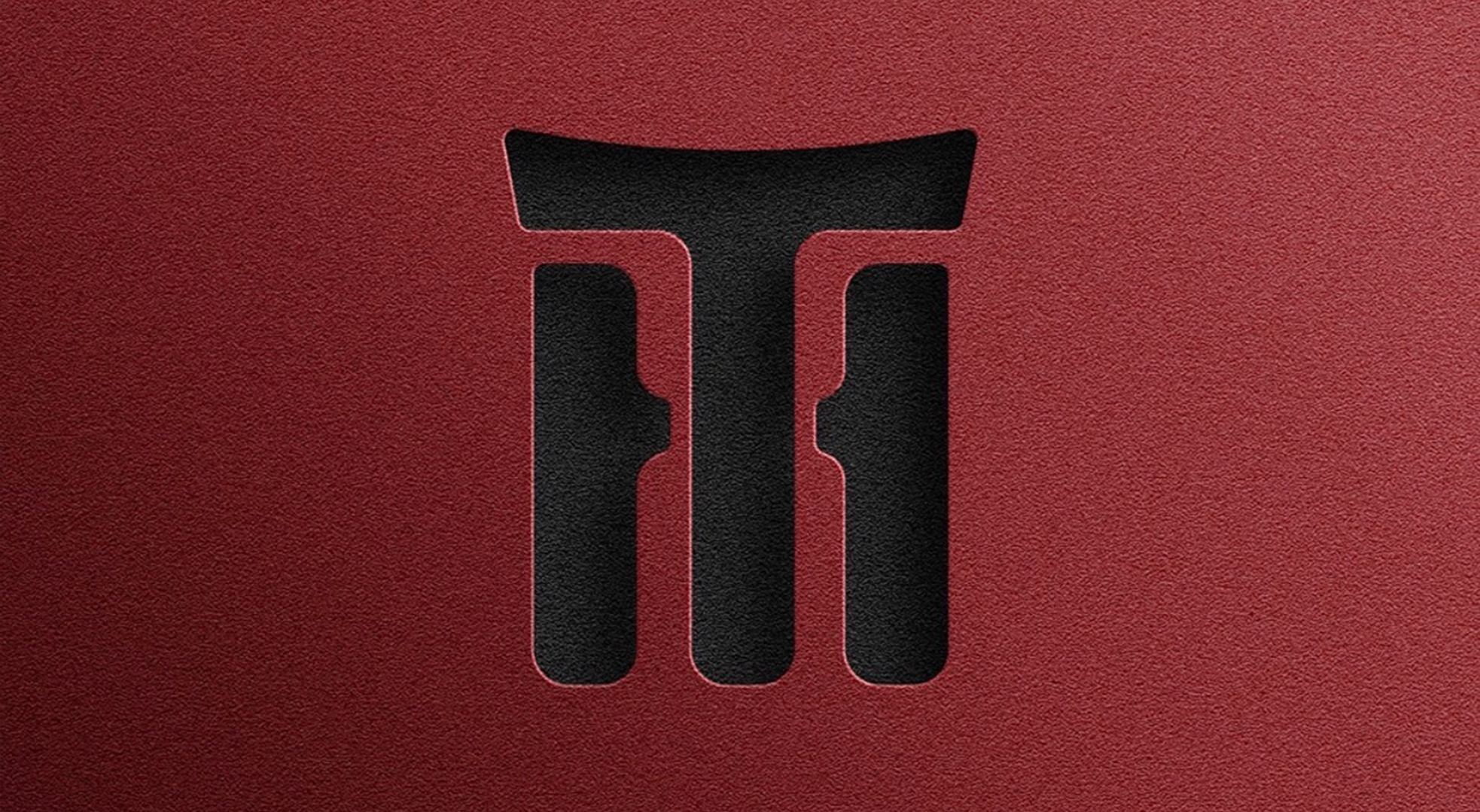 TeaHouse logomark debossed into a deep red textured surface